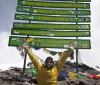 Spencer West at the summit of Mount Kilimanjaro